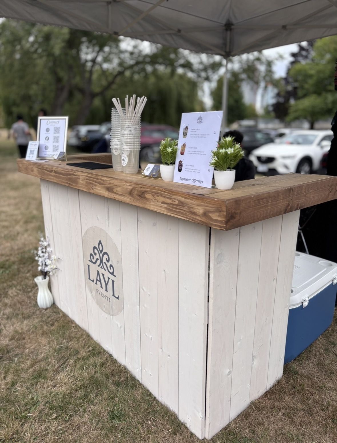 The Layl pop-up mocktail bar set up under a white tent at an outdoor event