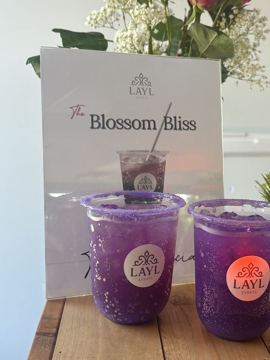 Two Blossom Bliss mocktails with a menu card and roses